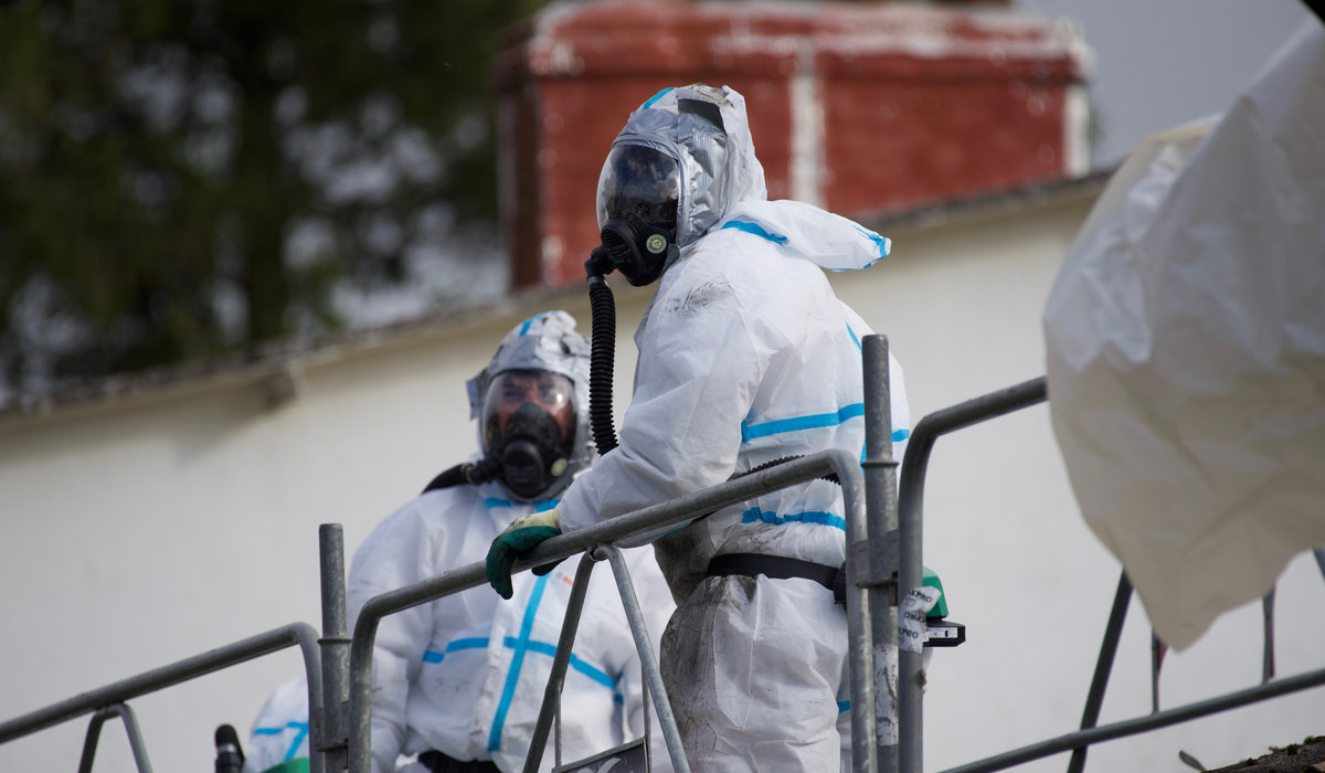 Worker wearing protective equipment during asbestos-related removal work