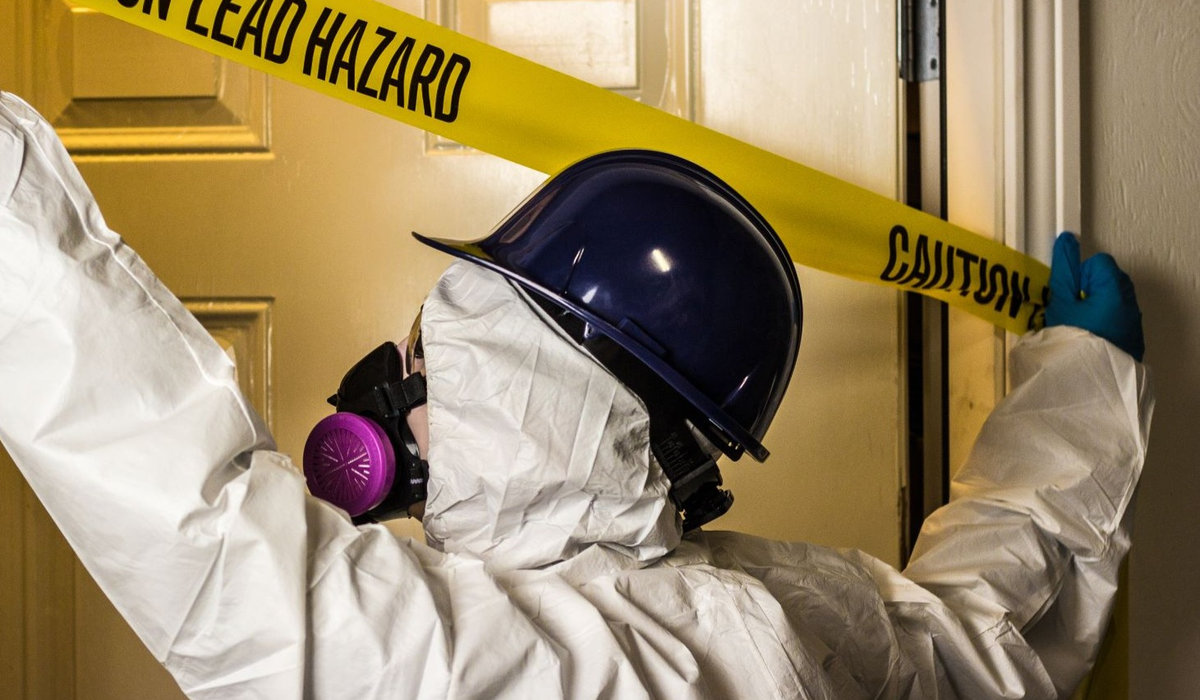 Professional performing lead hazard removal work inside a building